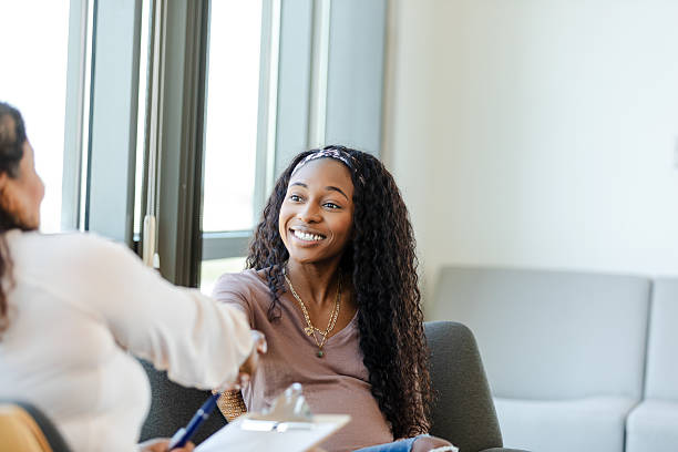 istock Happy Young Woman Shaking Hands with Therapist During Counseling Session 2229743174