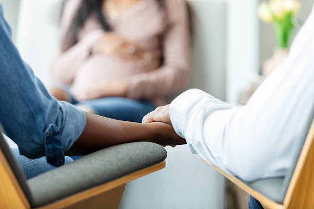 istock Couple holding hands during pregnancy counseling session 2229743234