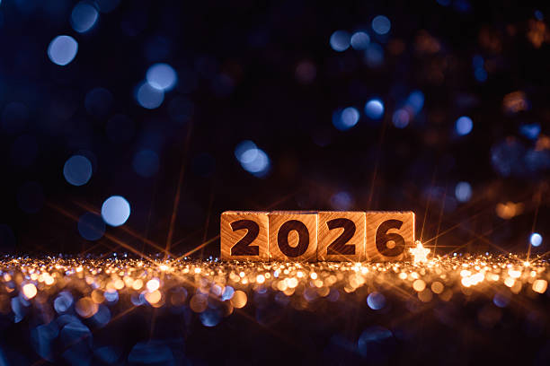 istock Wooden Number Blocks Displaying 2026 Surrounded by Glitter and Starry Lights 2229743897
