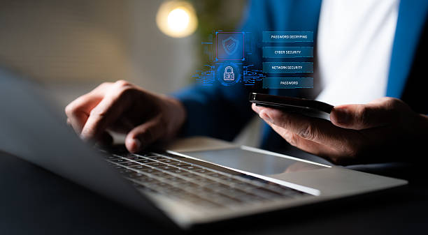 istock Hand of a man using mobile phone and laptop, secure access to user personal information, secure Internet access, information security encryption. Cybersecurity internet network data privacy concepts. 2229744892