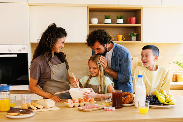 istock Loving family enjoying their time together preparing breakfast in a modern kitchen 2229746628