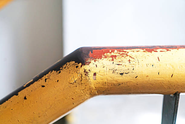Close-up view of a worn golden handrail showcasing unique textures and colors. Ideal for design, architecture, and interior decoration themes.