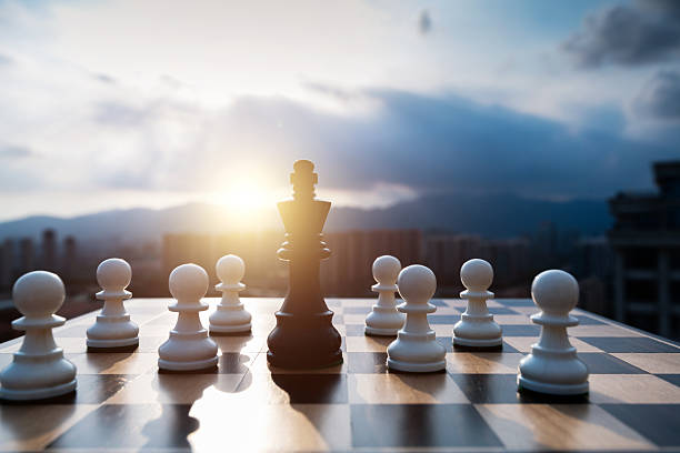istock Black chess king and white pawns on the chess board 2229751774