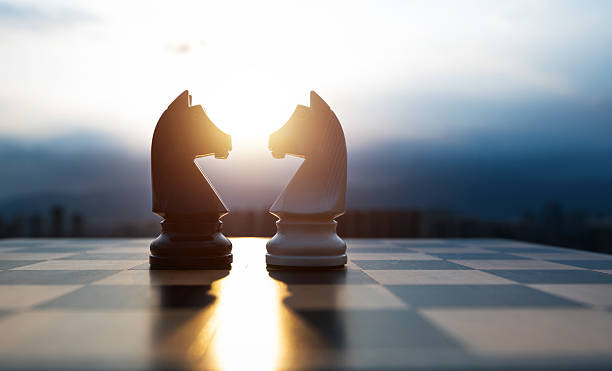 istock Two chess knights on city background 2229751783