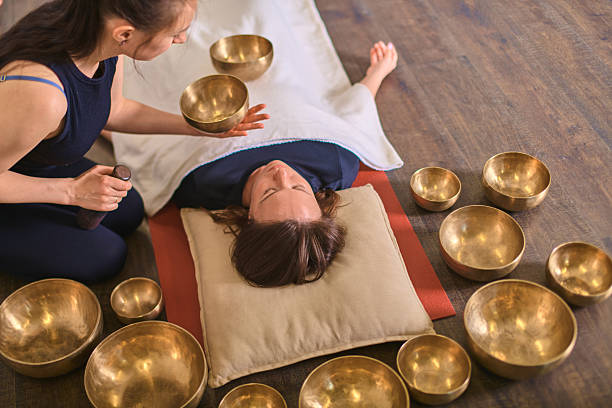istock Relaxation session with singing bowls on wooden floor 2229757023