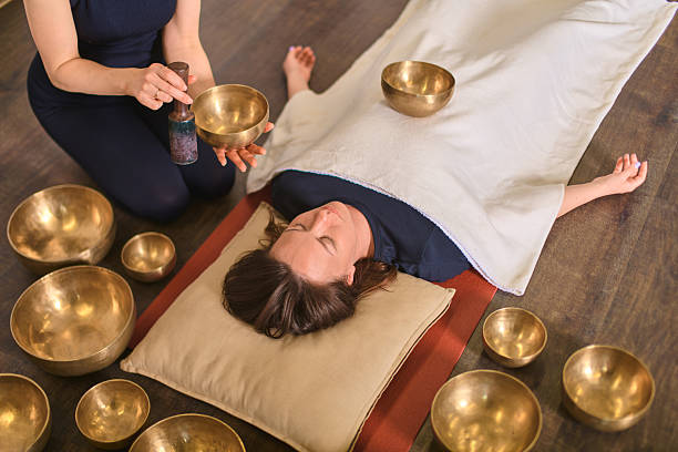 istock Relaxation session with singing bowls on wooden floor 2229757118