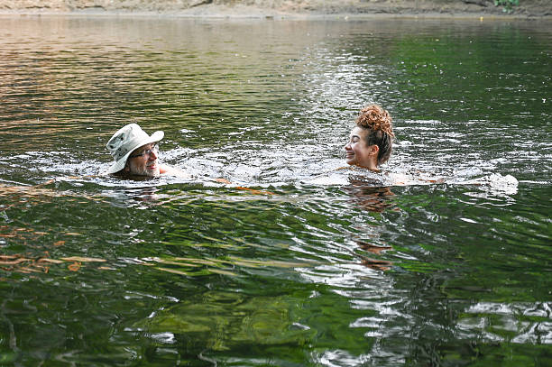 istock Father and daughter swimming in river 2229757705