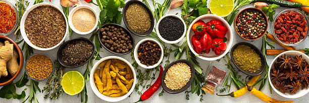 istock Assorted cooking spices and herbs arranged on a gray surface, featuring natural tones that add depth and aroma to any meal, banner 2229757865