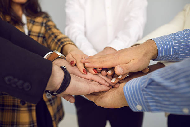 istock Multiracial business team hands in closeup showing teamwork shot side view 2229759507