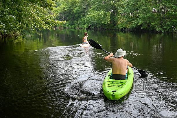 istock Father and daughter gliding on river 2229760007