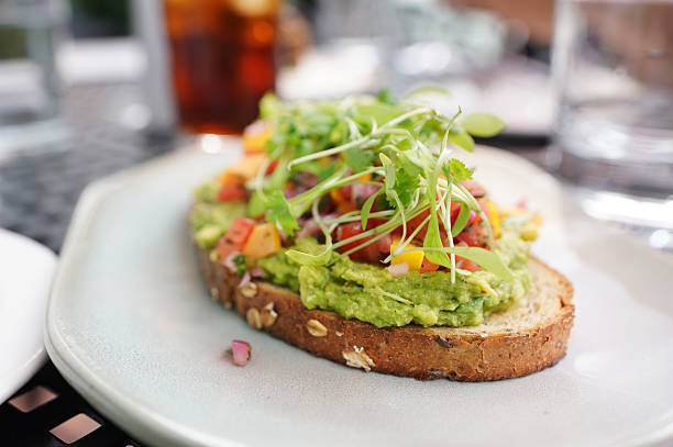 istock Gourmet avocado toast on artisinal bread with pickled mango and microgreens 2229760144
