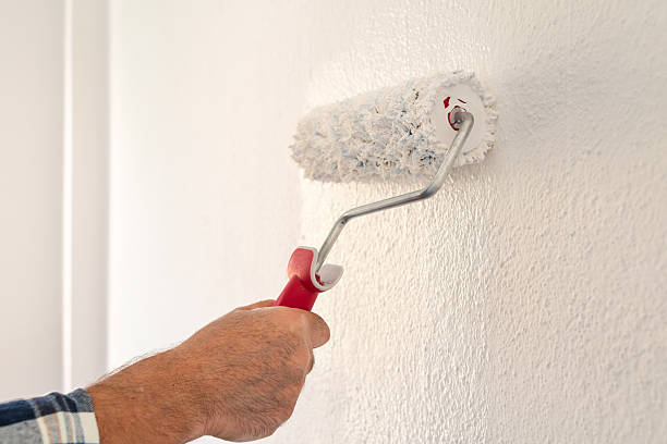 istock House painter worker painting a wall white. Building. 2229761431
