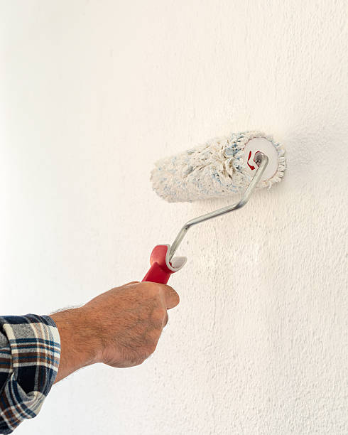 istock House painter worker painting a wall white. Building. 2229761453