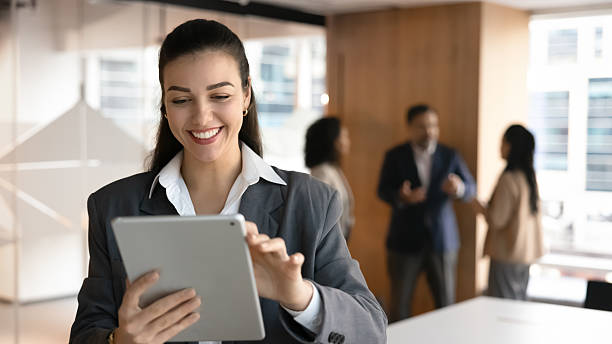 istock Cheerful millennial businesswoman networking with client using digital pad 2229763310