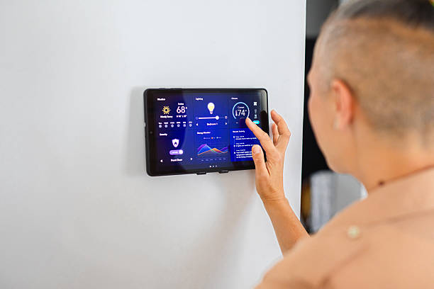 istock Woman browsing smart home control features on a tablet, including temperature, lighting, and energy statistics 2229763572
