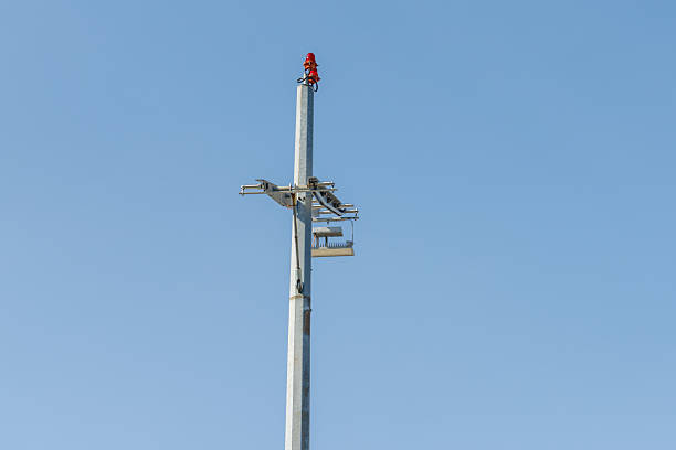 istock Metal Tower with Red Light Against Blue Sky 2229764521