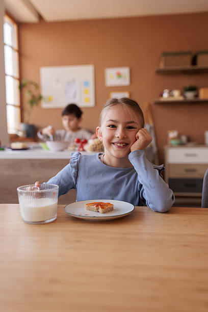 Young Girl Enjoying Morning Meal at Dining Table