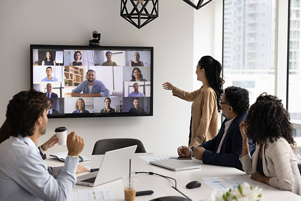 Diverse polyethnic office team hold video negotiations with remote partners