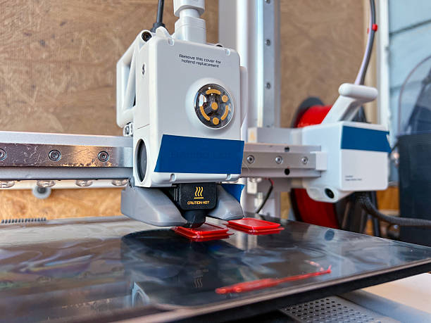 istock 3d printer creating red plastic parts in laboratory 2229769346