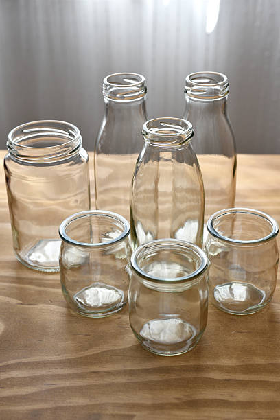 istock Glass jars and bottles on wooden table 2229777655