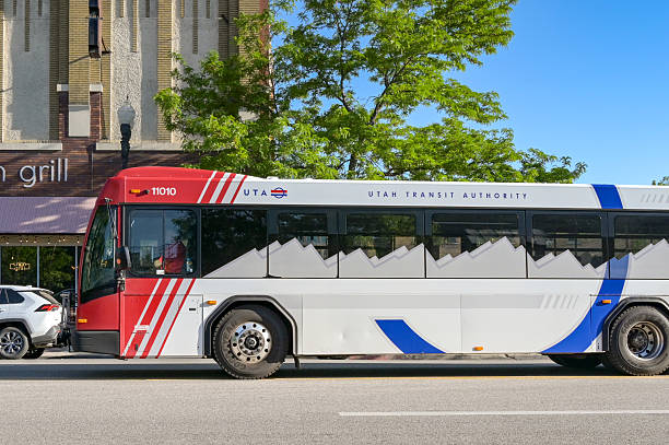 Ogden, Utah, USA - 27 May 2025: Public service bus operated by the Utah Transit Authority driving on one of the main streets of Ogden