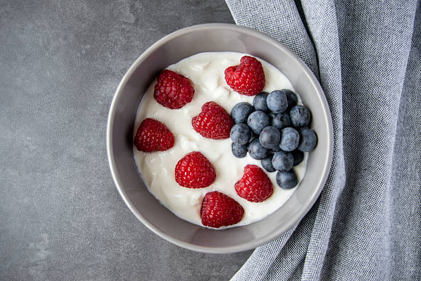 istock Gray ceramic bowl and natural yogurt with berries on the stone marble table. 2229780909