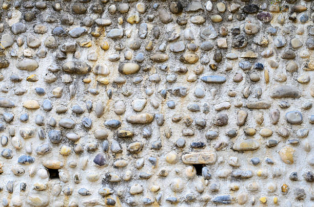 istock Wall made of river pebbles with unique texture and natural background 2229782219