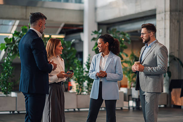 istock Business people talking during coffee break in modern office 2229782260