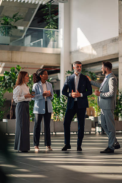 istock Business team discussing strategy in modern office lobby 2229782261