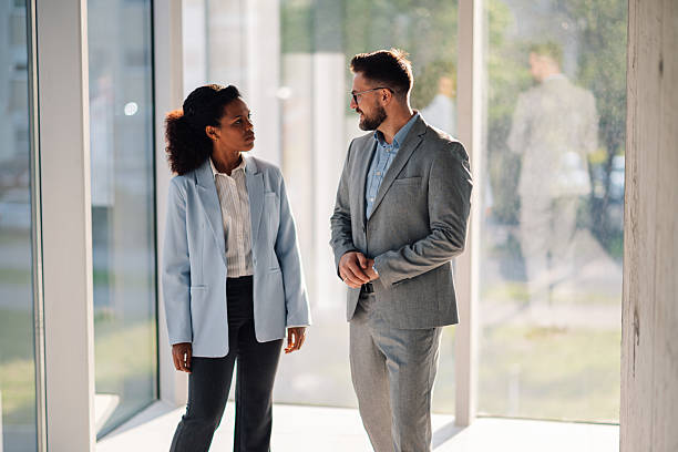 istock Businesspeople discussing near office window in modern building 2229782694