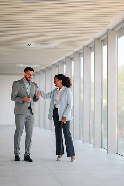 istock Businesspeople discussing work in modern office corridor 2229782806