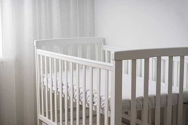 istock Modern white baby crib in minimalist nursery, space for text. 2229785079