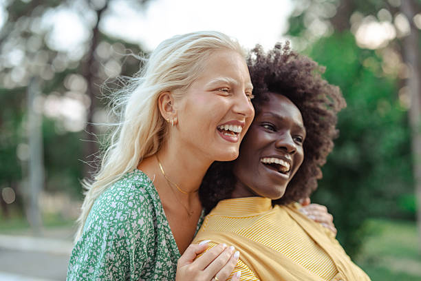 istock Two diverse women sharing a joyful moment outdoors 2229785632