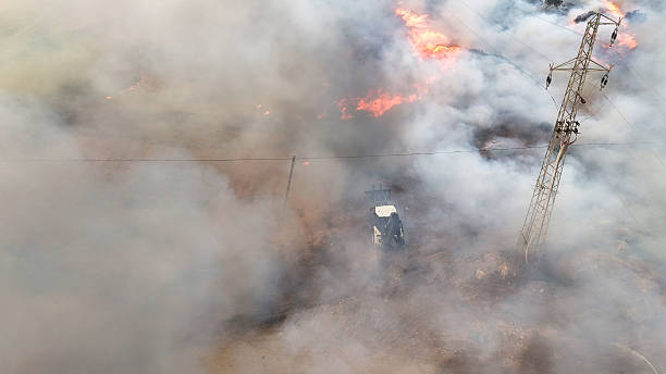 istock Wildfire with Smoke, Flames, and Power Transmission Tower 2229786732