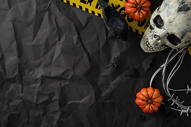istock Creepy Halloween setup featuring a skull, pumpkins, a black raven, caution tape, and a spider. Perfect for spooky occasions, festive season decor, or scary themed imagery 2229790829