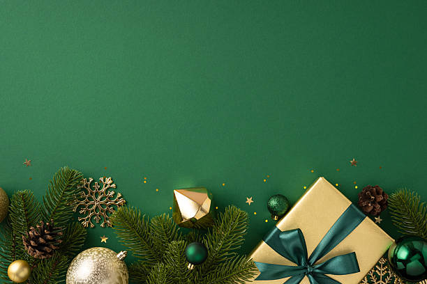 istock Festive Christmas composition featuring a golden gift box with ribbon surrounded by ornaments. Green background enhances holiday spirit. Perfect for Christmas decorations, celebrations 2229790831