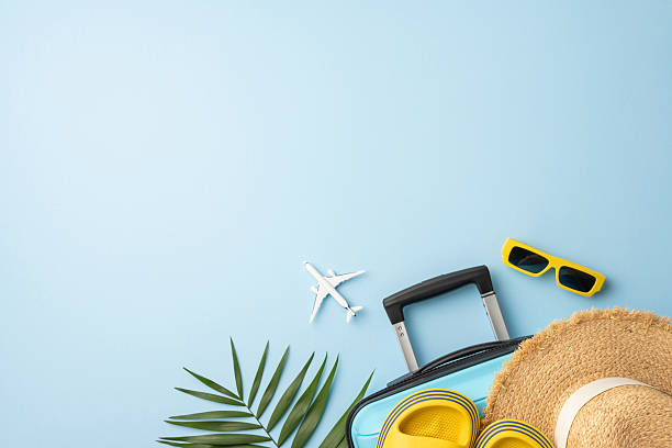 istock Travel essentials arranged on a blue surface featuring a tropical vibe perfect for summer vacations 2229790837