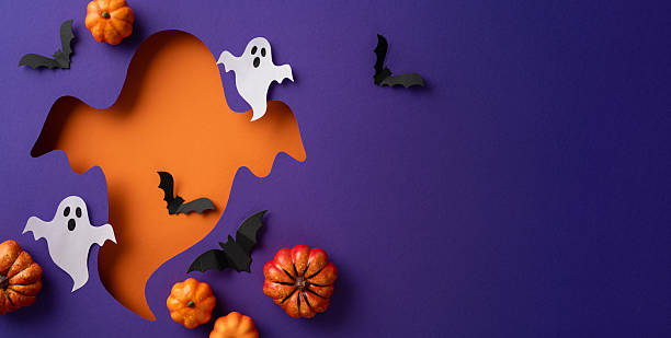 istock A creative Halloween themed display featuring cutout elements of ghosts, bats, and pumpkins on a vibrant purple and orange background 2229790858