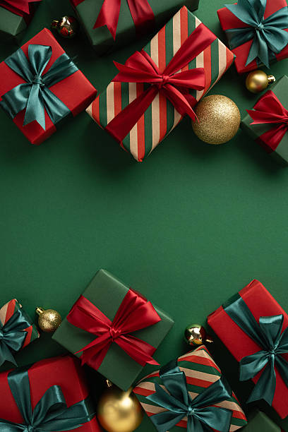 istock Festive vertical gift boxes wrapped with ribbons and joined by golden ornaments creating holiday joy 2229790885
