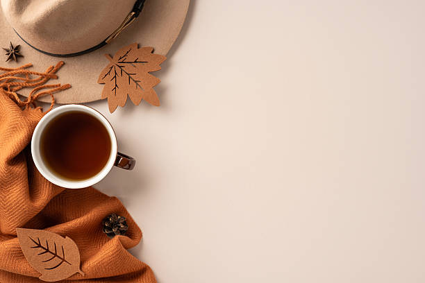 istock Warm and inviting autumn setup featuring a cup of coffee, a hat, and a cozy scarf 2229790922
