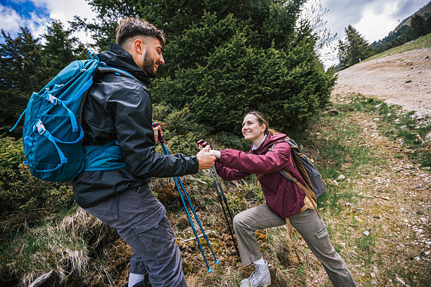 istock Hiking Couple Helping Each Other on Mountain Trail 2229791115
