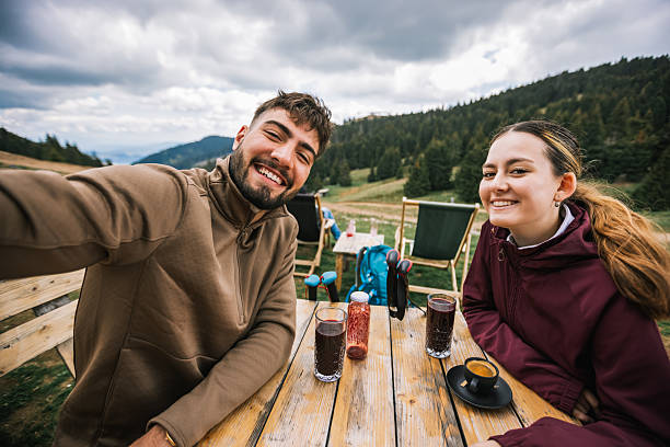 istock Hikers Taking Selfies with Scenic Mountain View 2229791197