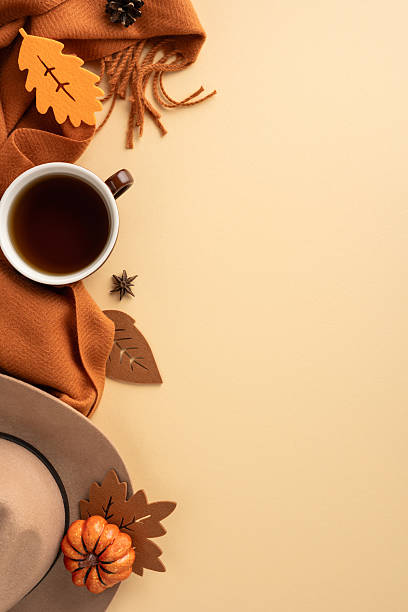 istock Warm vertical autumn composition featuring a cup of coffee on beige background surrounded by seasonal accessories 2229793626