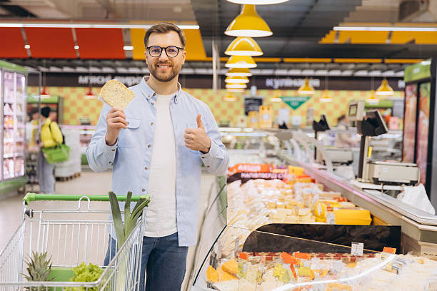 istock Customer Showing Thumbs Up While Holding Pita Bread in Supermarket 2229793817