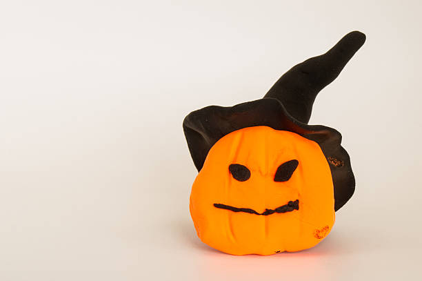 Halloween pumpkin made of polymer clay on a white background