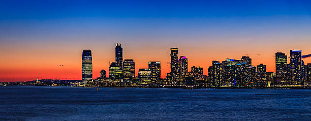 istock Jersey City skyline silhouette from New York, dramatic sunset over Hudson River 2229797760