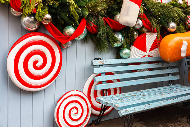 Decorative candy themed bench with festive garland in a holiday display setting