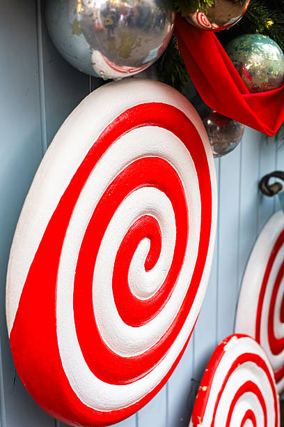 istock Decorative candy themed display with large lollipops adorned in red and white colors 2229799001