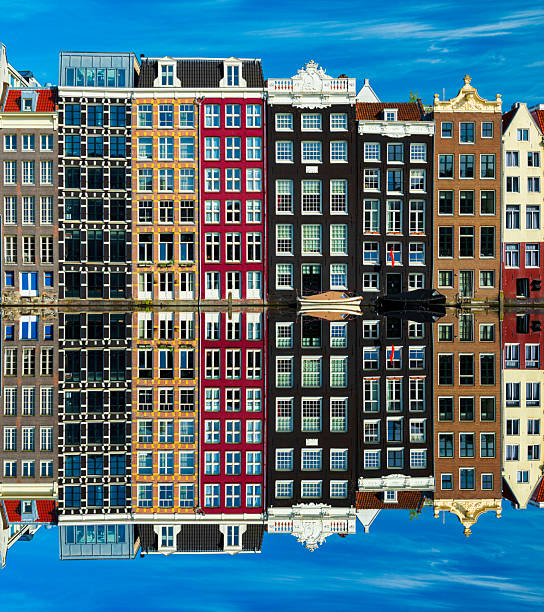 Sunshine illuminates 17th and 18th centry traditional Dutch Dancing Houses on a canal in Amsterdam, Netherlands