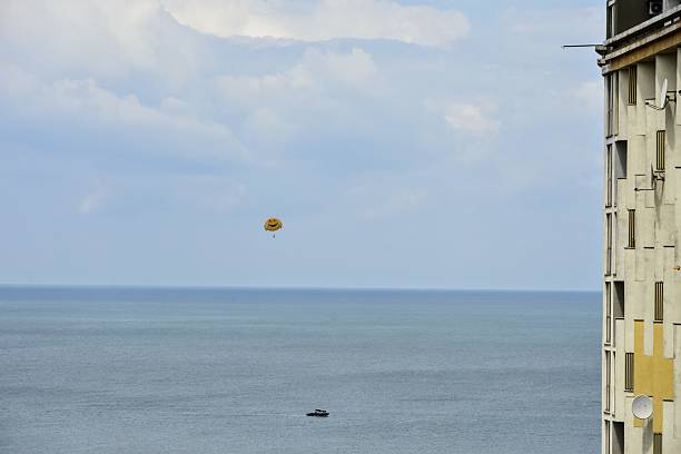 Two women challenging parasailing in Guam
